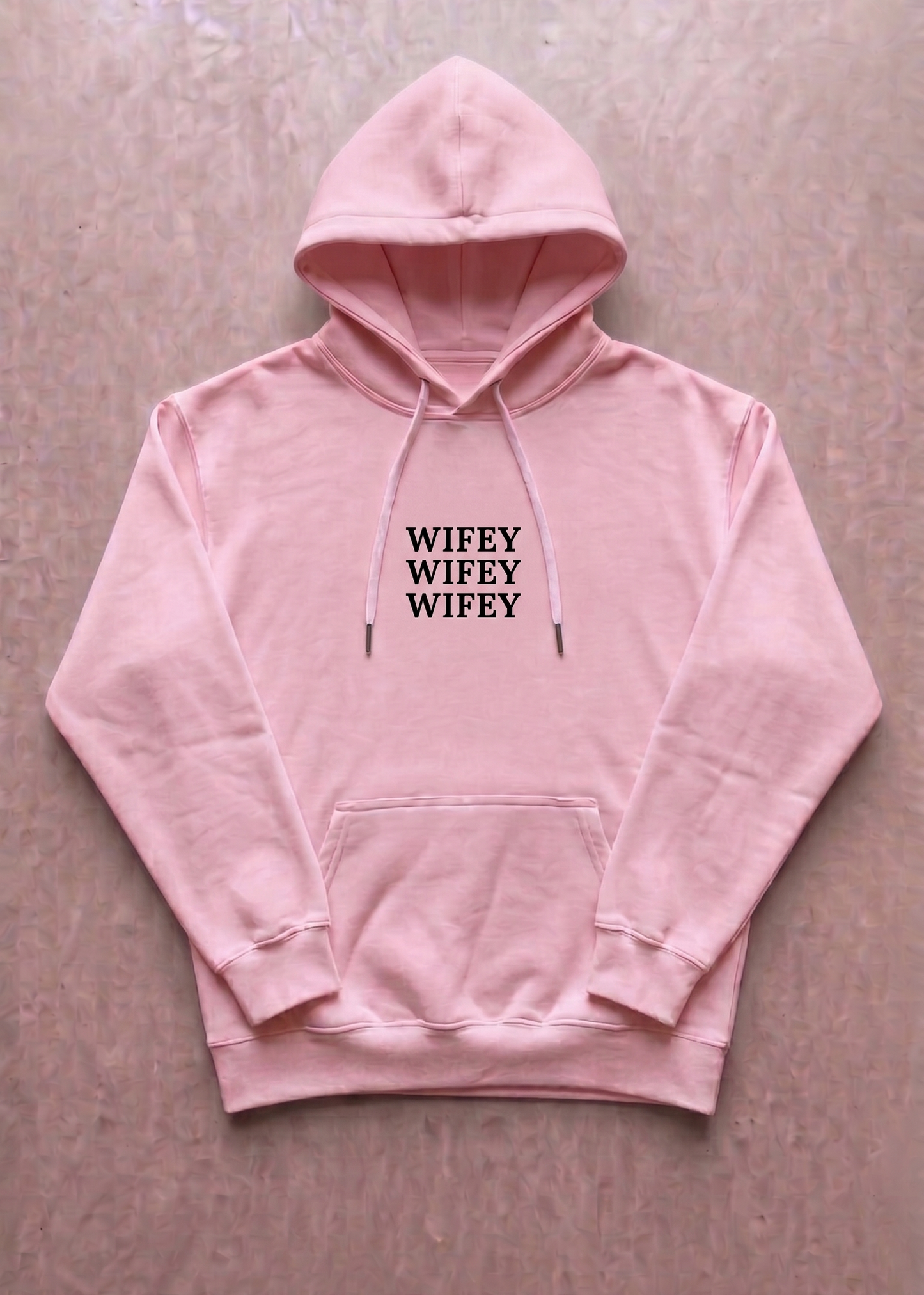 Pink hoodie with 'SNIPER' text on a beige background