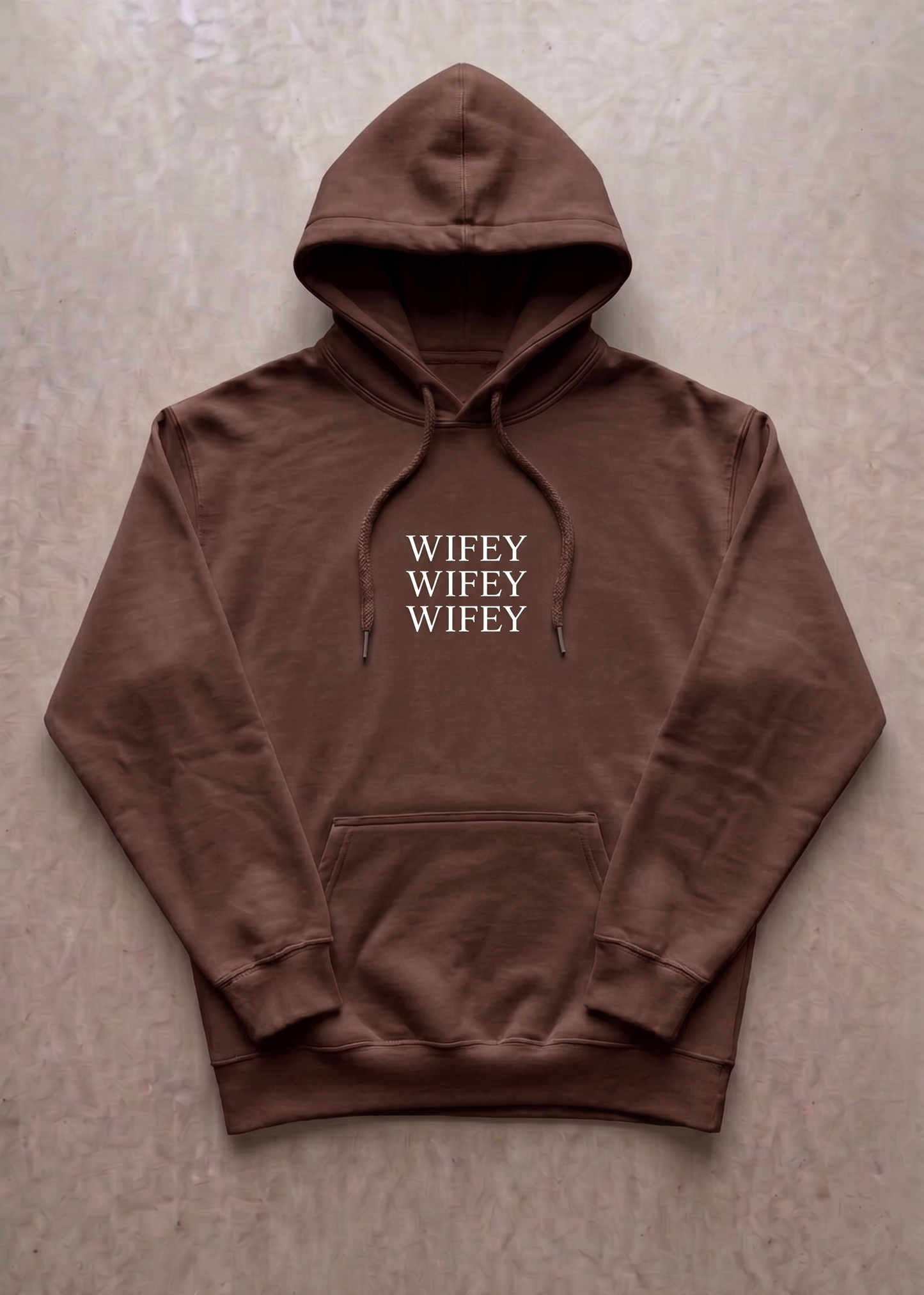 Brown hoodie with 'WIFEY' text on a beige background