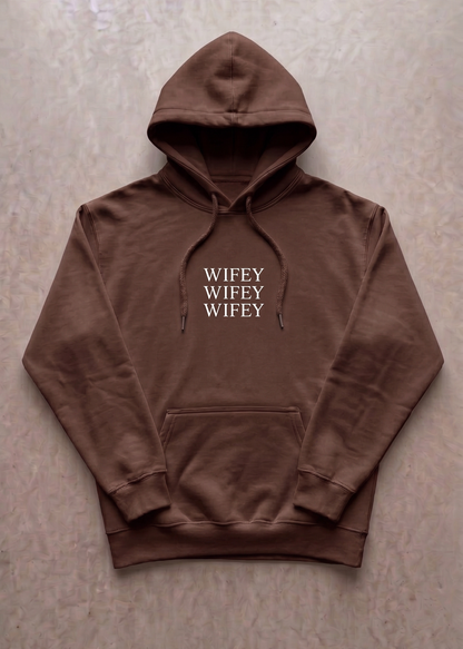 Brown hoodie with 'WIFEY' text on a beige background