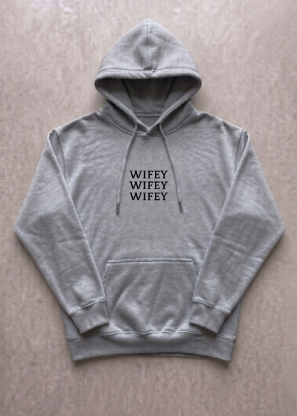 Gray hoodie with 'WIFEY WIFEY WIFEY' text on a beige background