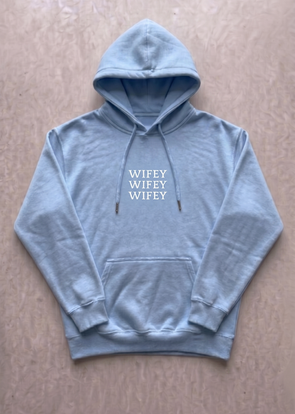 Light blue hoodie with 'WIFEY' text on a beige background