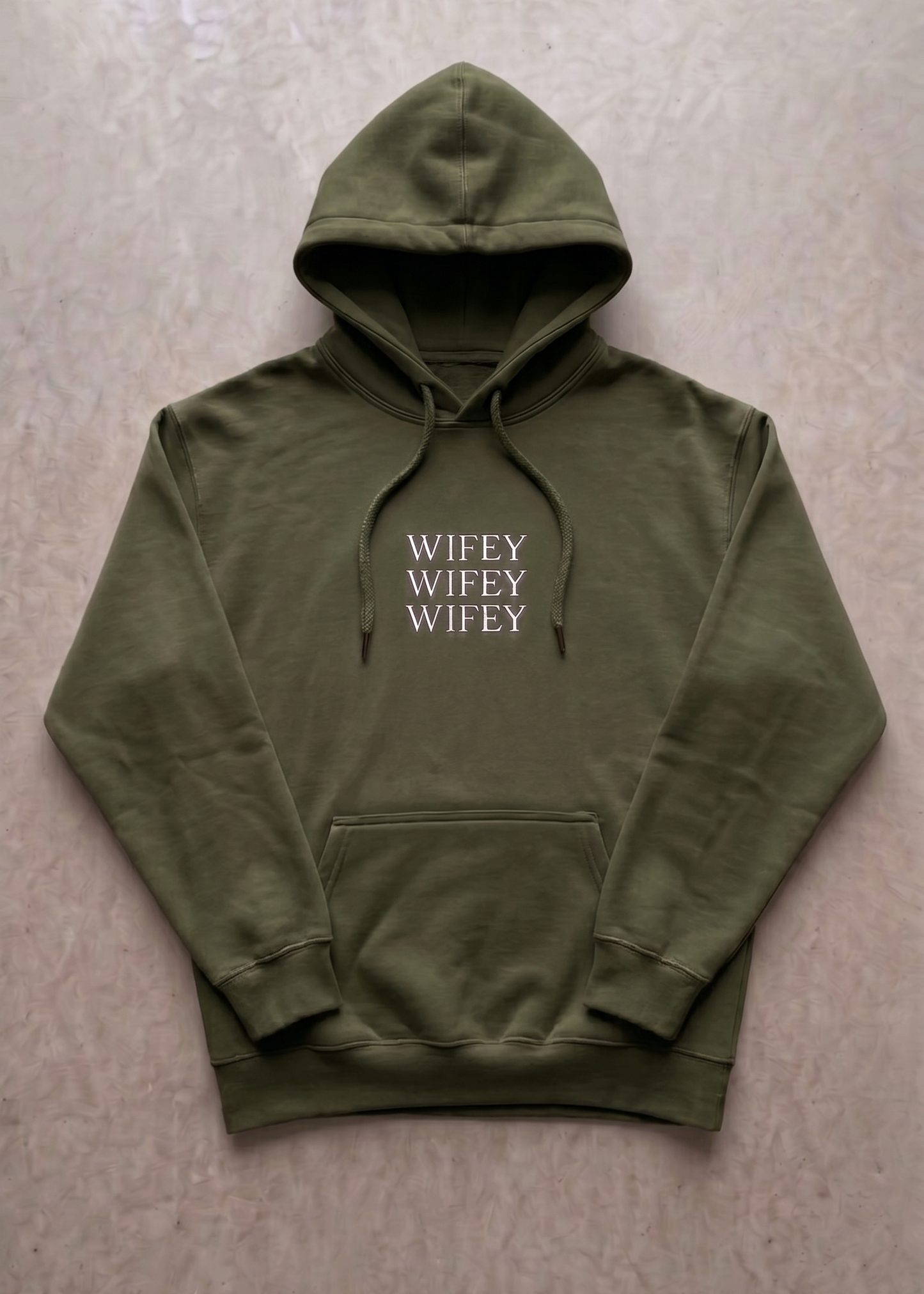 Green hoodie with 'WIFEY' text on a beige background