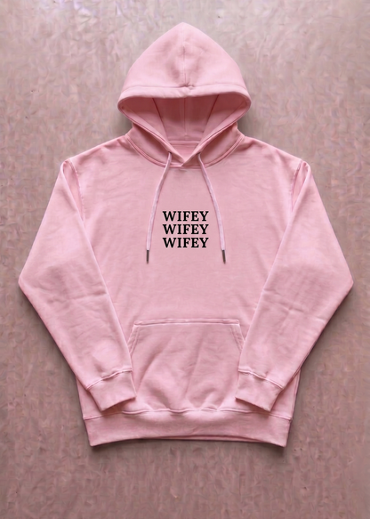 Pink hoodie with 'SNIPER' text on a beige background