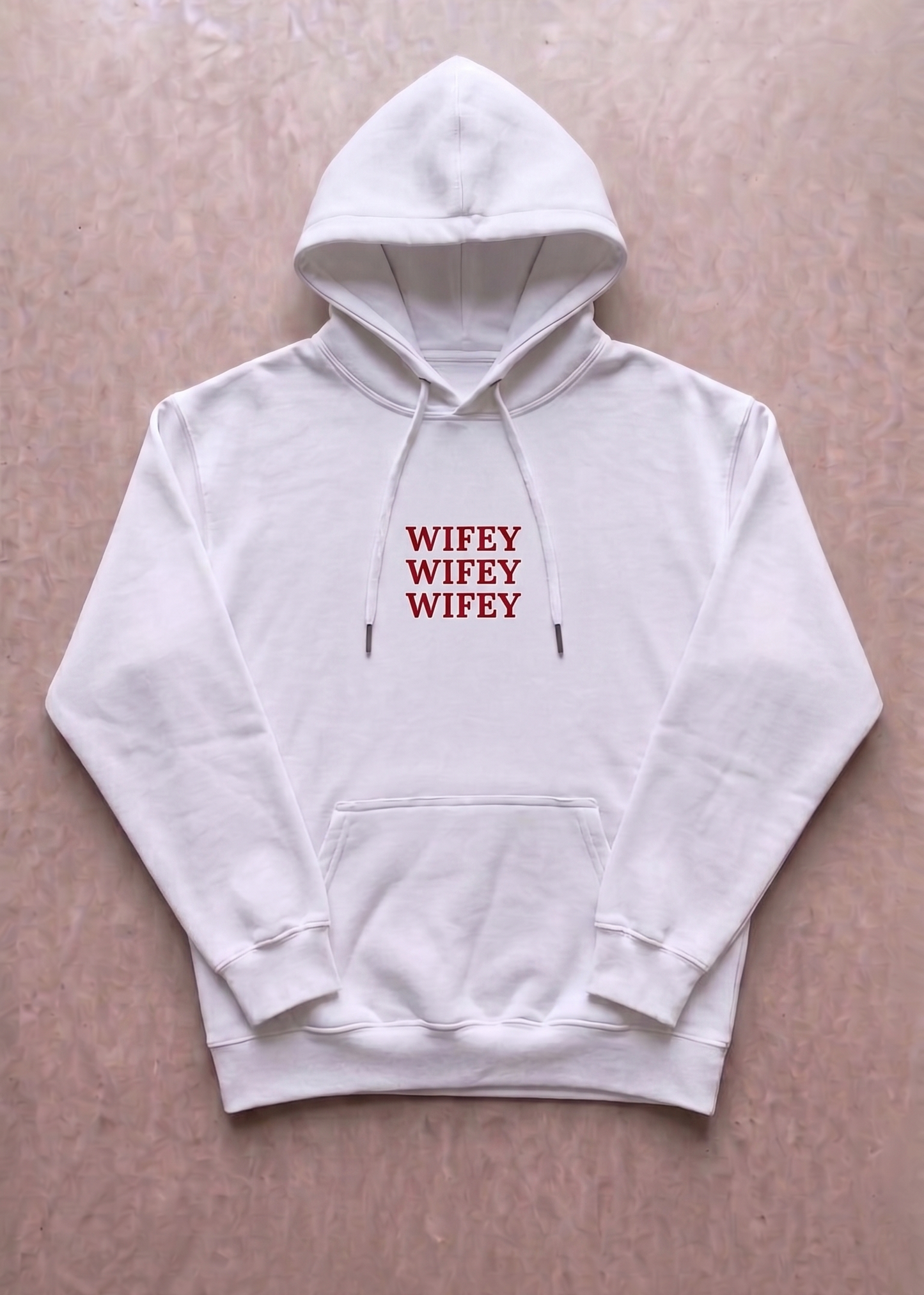 White hoodie with 'WIFEY' text printed in red on a beige background